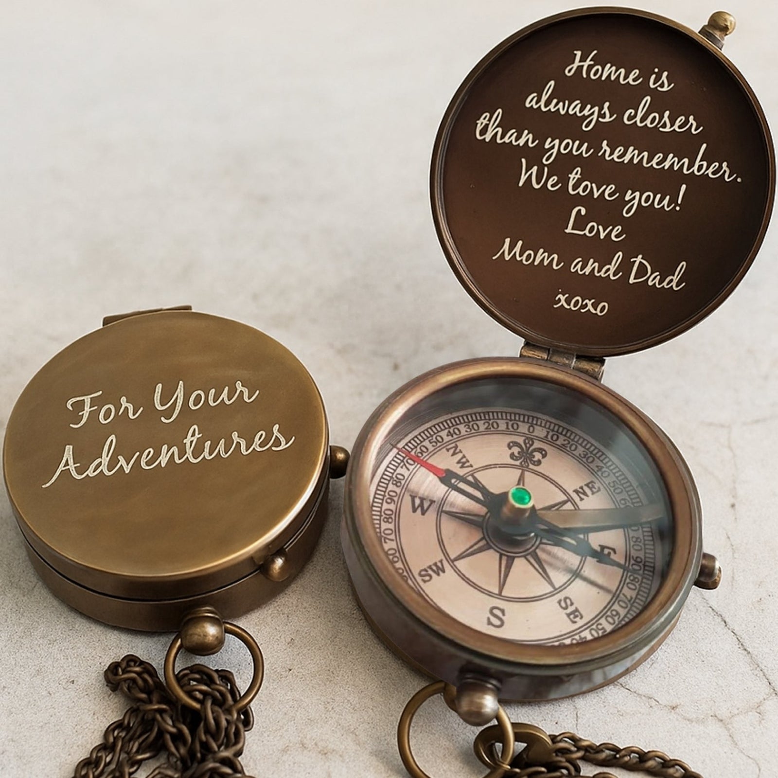 Bronze compass with engraved message on a light background