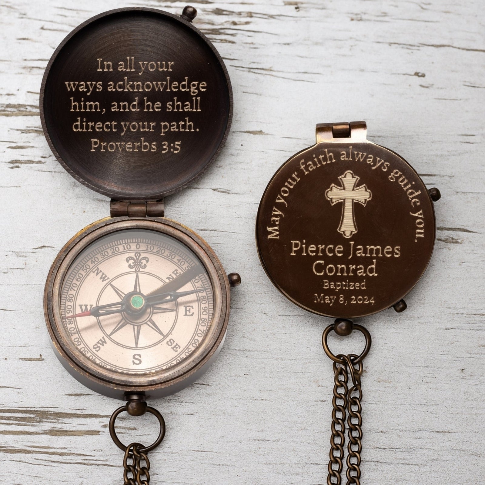Bronze compass with engraved text on a wooden surface