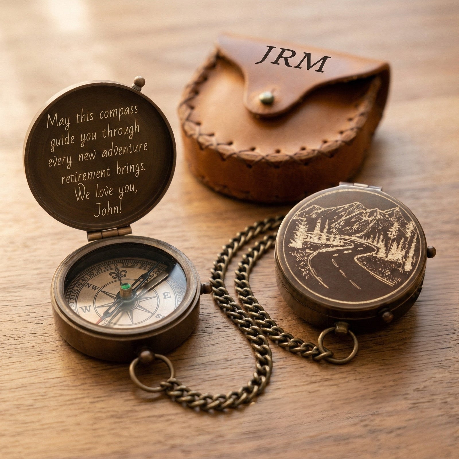 Personalized compass with engraved message and leather case on a wooden surface