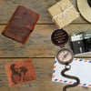 Flat lay of personalized leather wallet, compass, and journal with engraved messages – heartfelt gifts by SFdizayn
