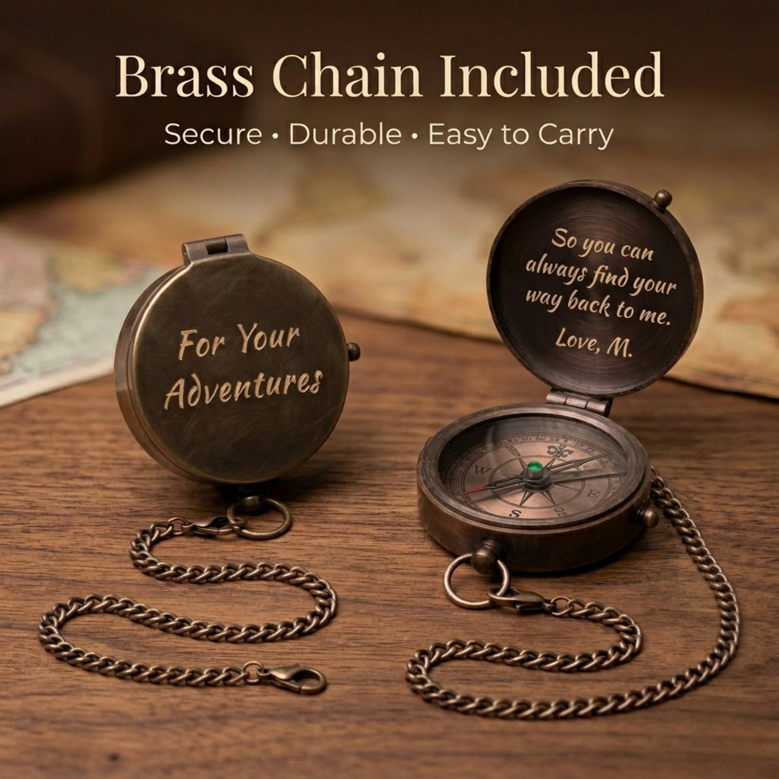 Two bronze compasses with engraved text on a wooden surface, accompanied by a brass chain.