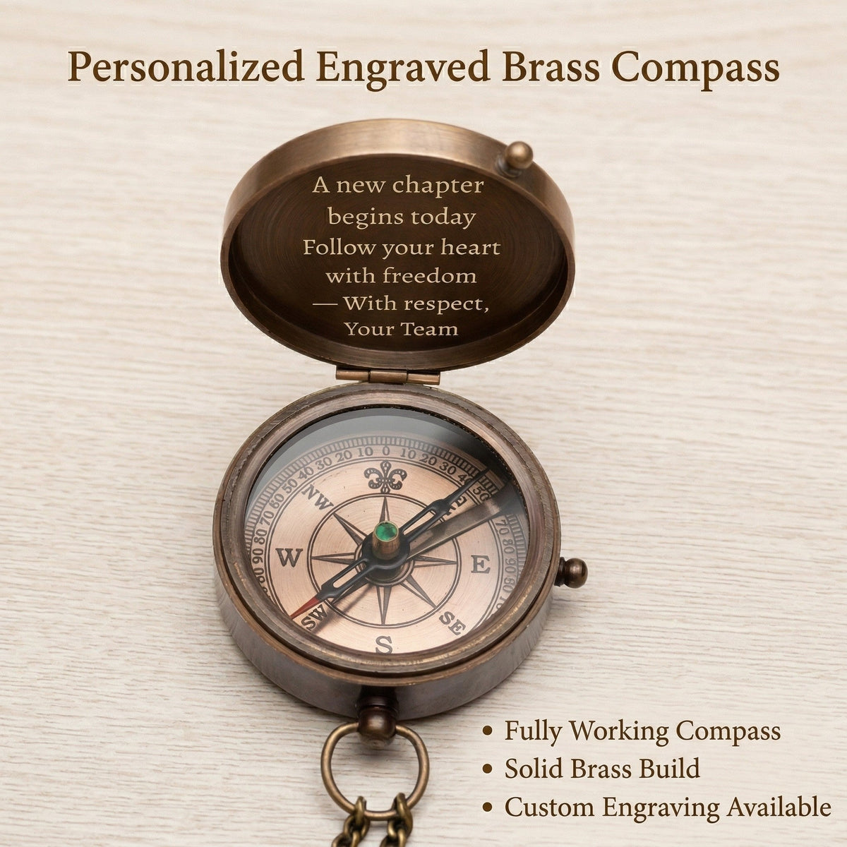 Personalized engraved brass compass with engraved message on a textured beige background