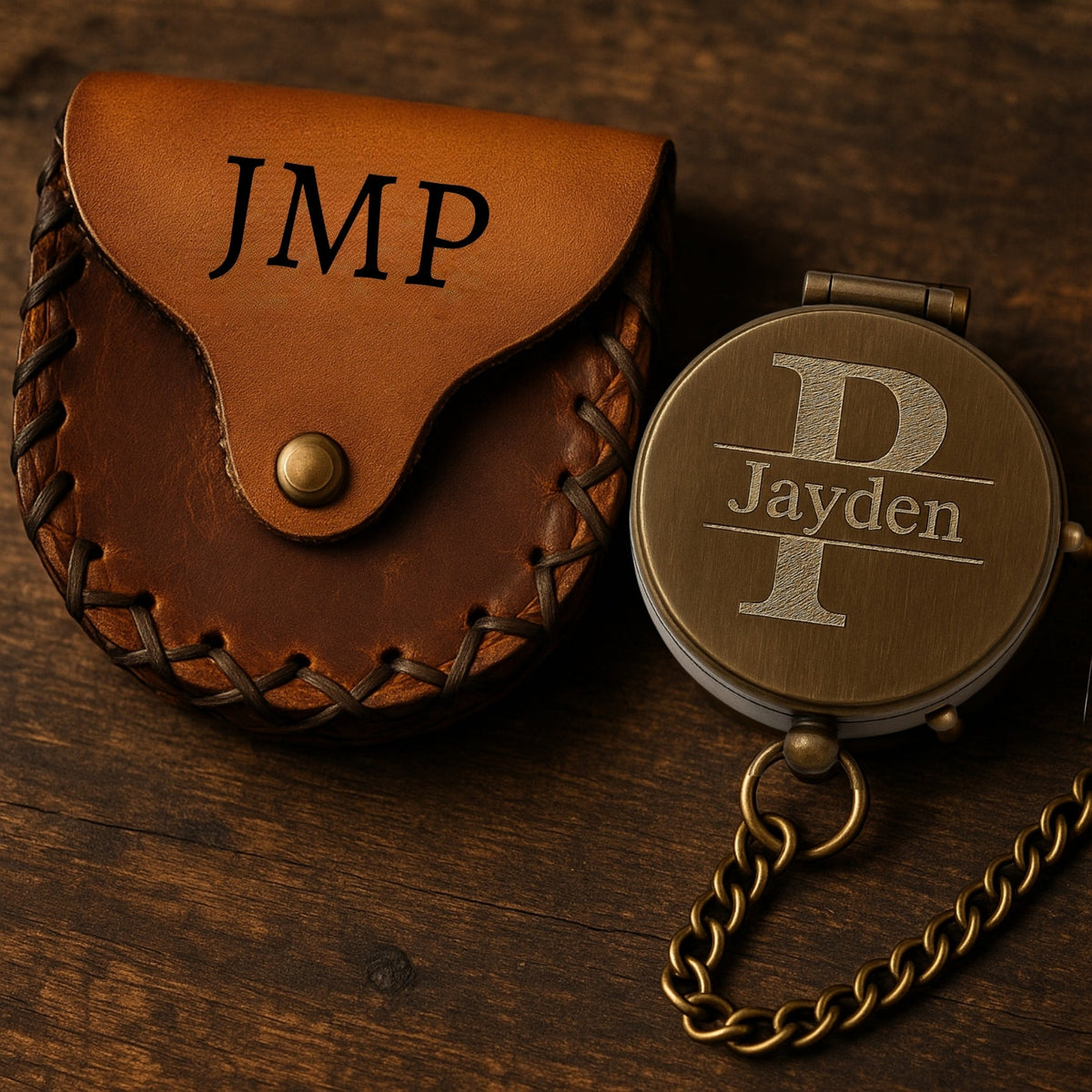 Brown leather pouch with &#39;JMP&#39; initials and a bronze compass with &#39;Jayden&#39; engraving on a wooden surface.