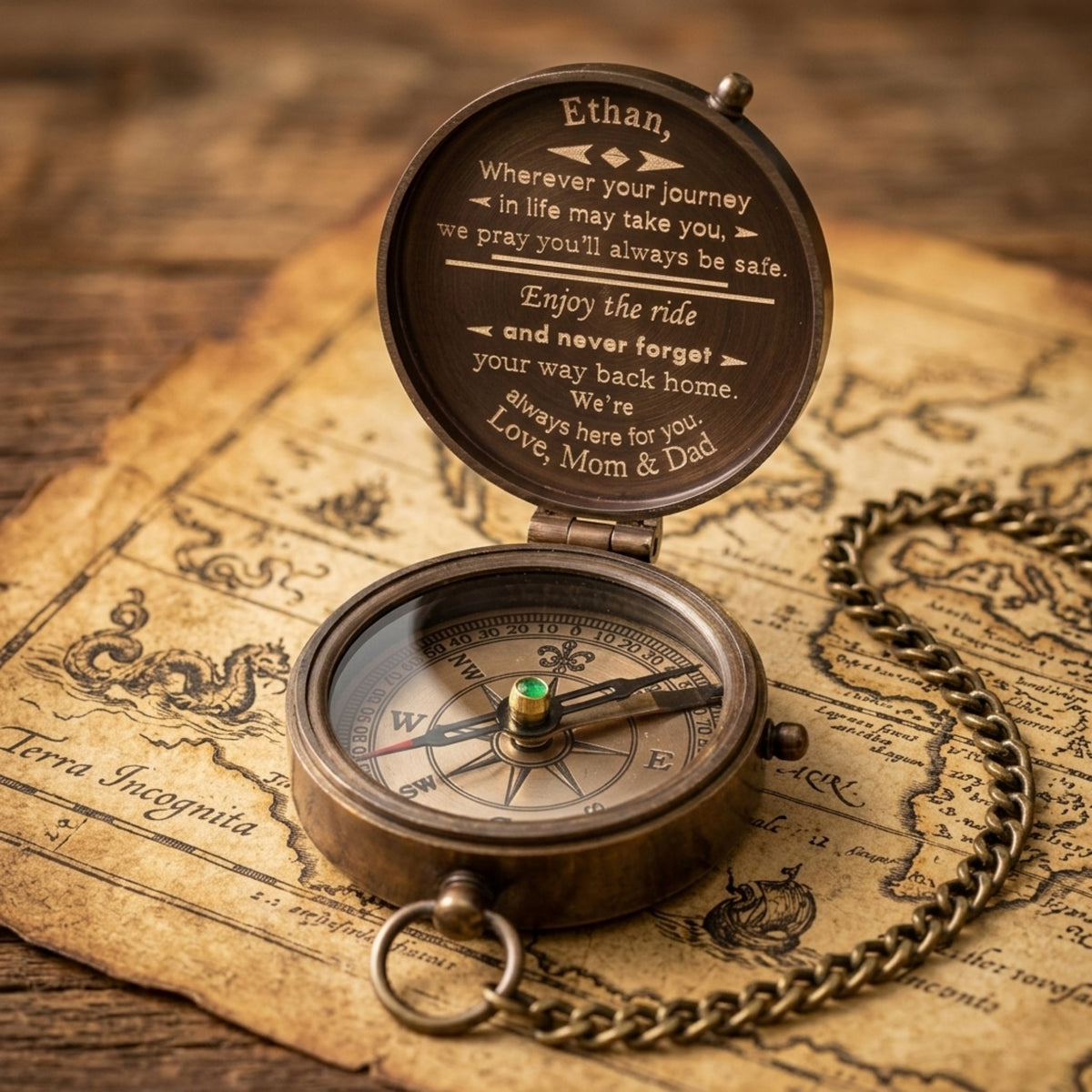 Bronze compass with engraved message on an old map