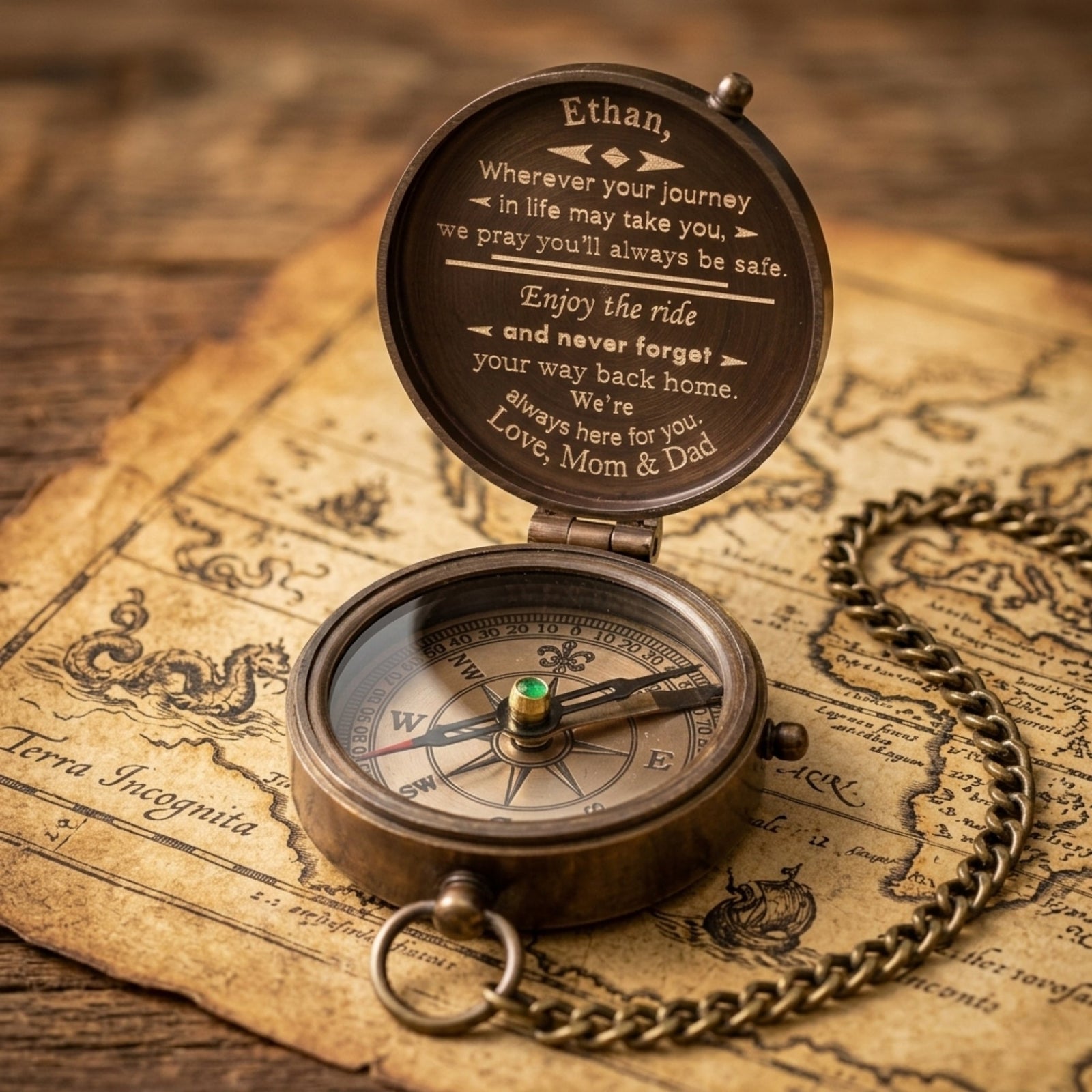Bronze compass with engraved message on an old map