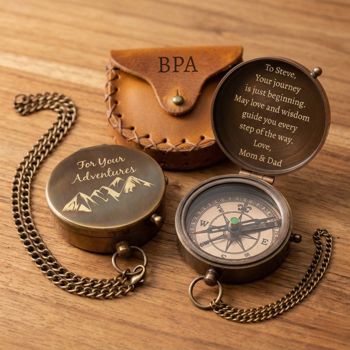 Personalized compass with engraved message on a wooden surface
